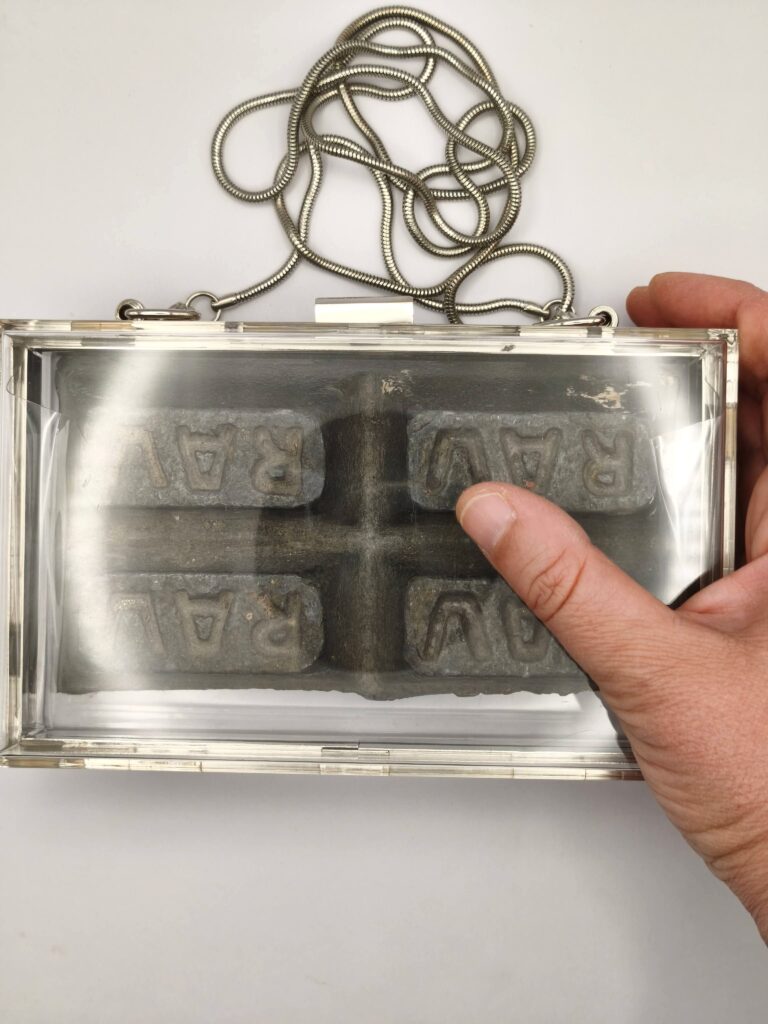 Bag Led — shown in hand for scale